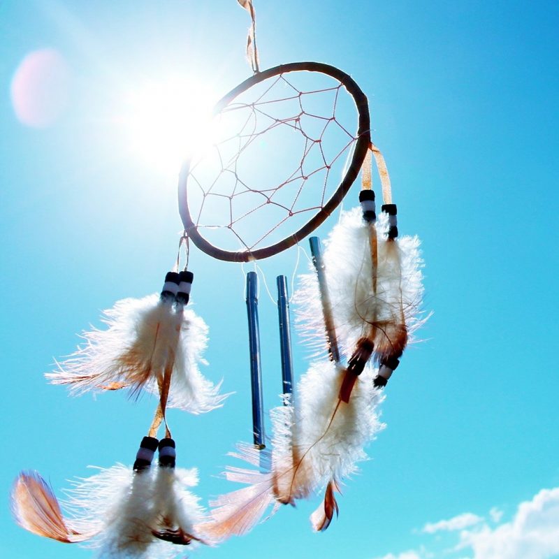 dreamcatcher hanging outside with bright blue sky