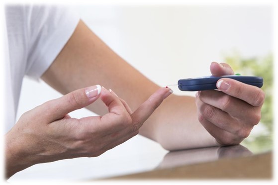 person pricking finger testing blood sugar